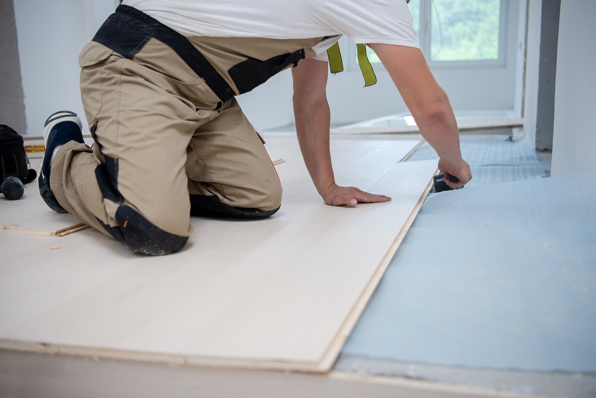 Professional Worker Installing New Laminated Wooden Floor